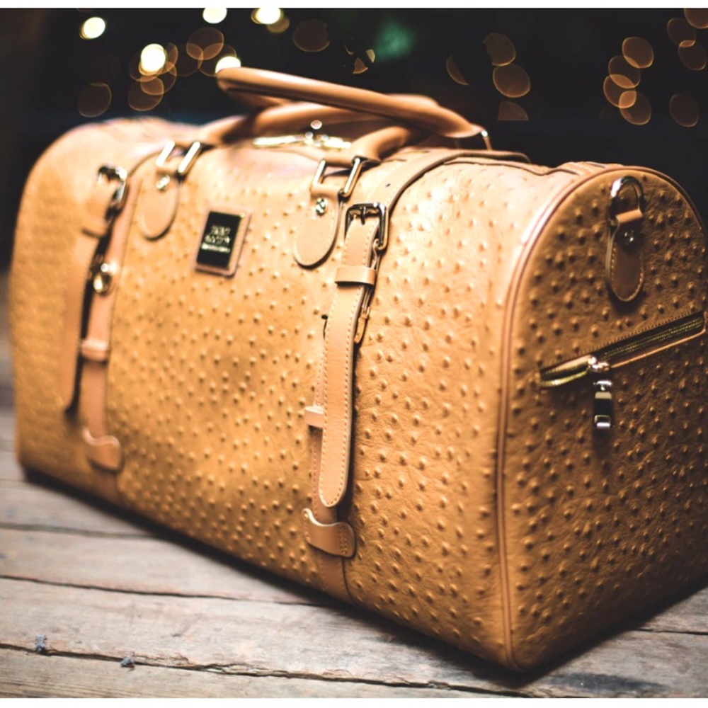 This high-end stylish yet convenient large duffle is constructed of real ostrich